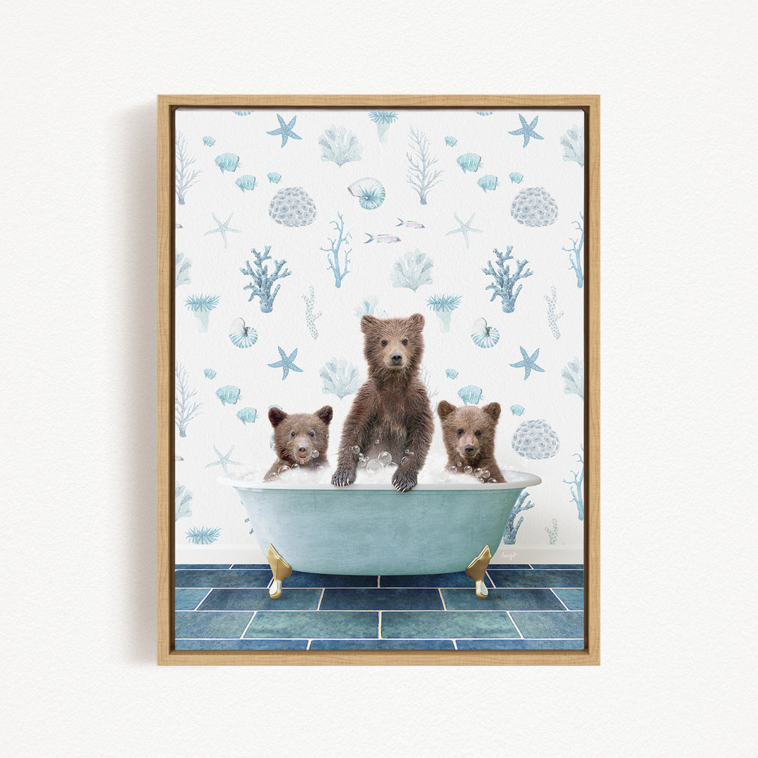 A framed print depicting three bears sitting in a bathtub filled with water, surrounded by a pattern of seashells, starfish, and other marine life.