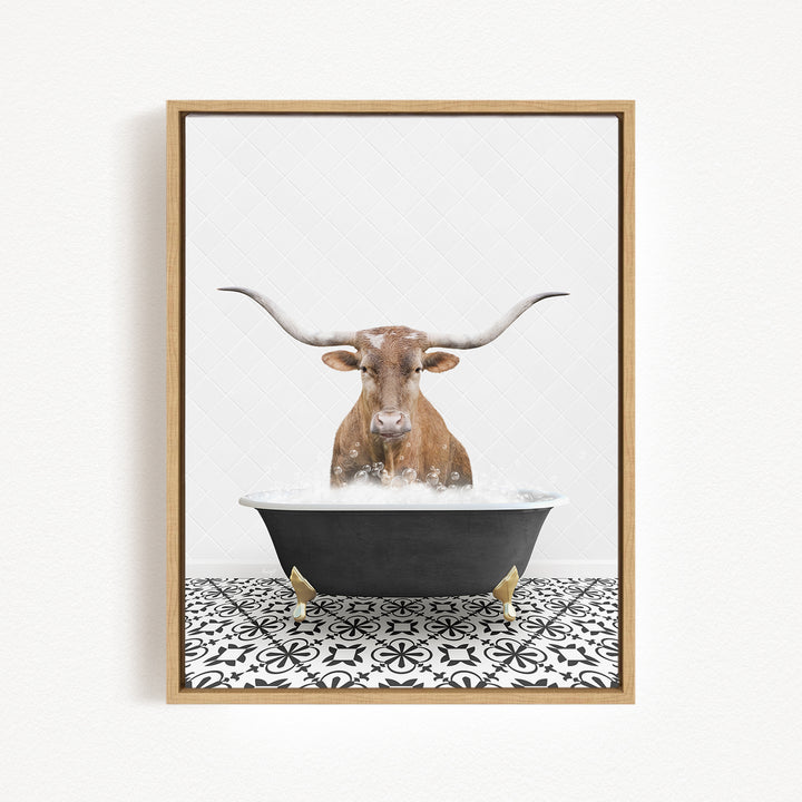 A brown bull with long horns is sitting in a black bathtub filled with water, creating a whimsical and playful scene.