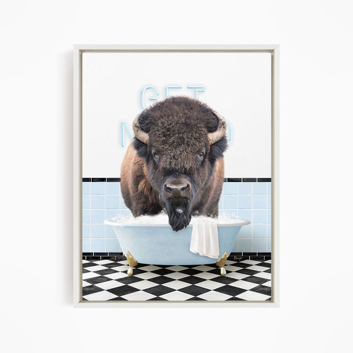 A buffalo standing in a bathtub filled with water, with a towel hanging over the side of the tub.