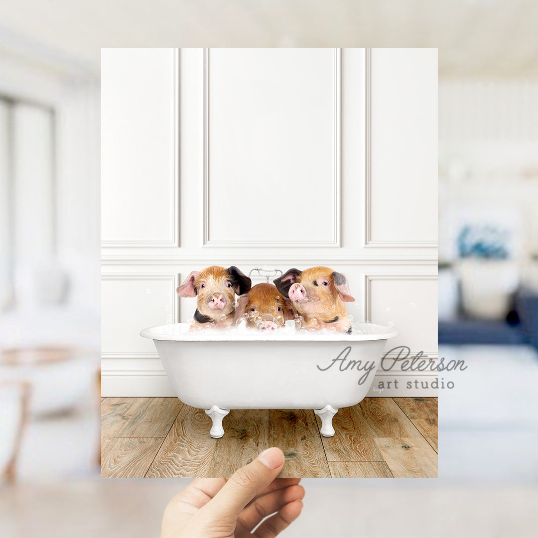 a hand holding a photo of three puppies in a bathtub