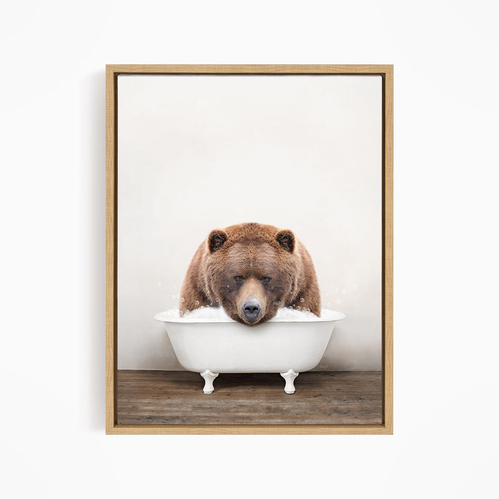 A brown bear sitting in a white bathtub, appearing to be enjoying a relaxing bath.