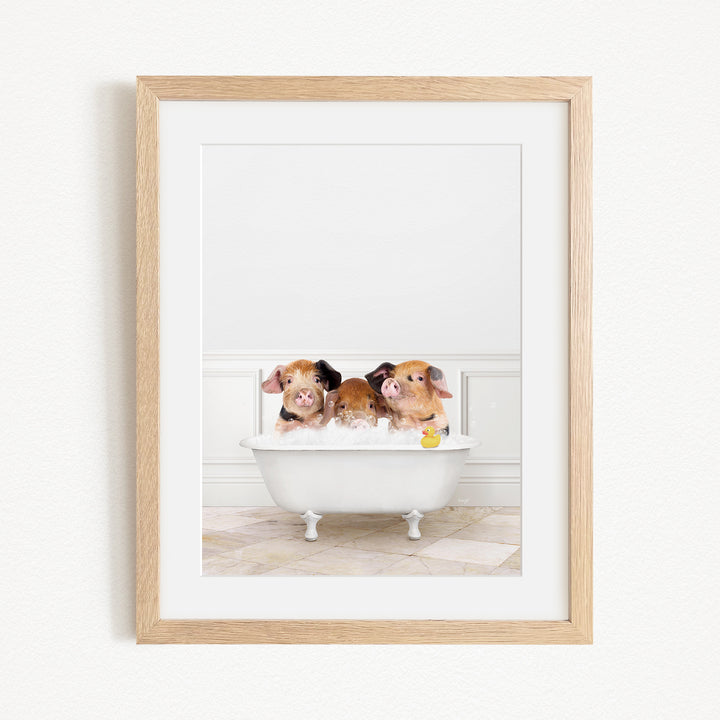 Three adorable pigs sitting in a white bathtub, enjoying a relaxing bath.