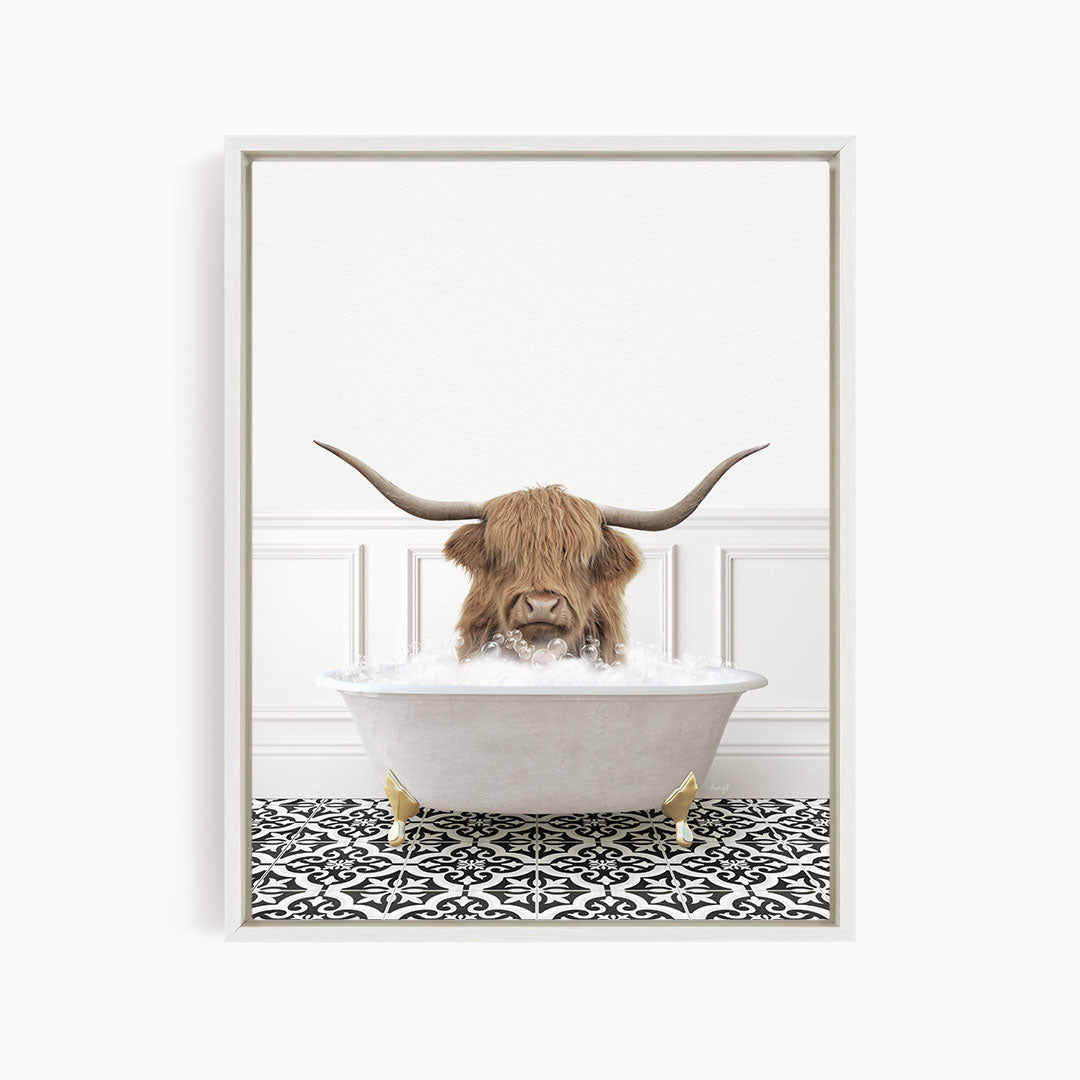 A brown cow with large horns is sitting in a white bathtub filled with water, creating a whimsical and humorous scene.