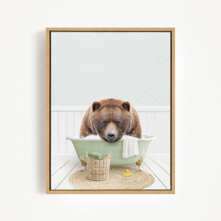 A brown bear is sitting in a green bathtub, surrounded by a basket of toys and a yellow rubber duck, creating a whimsical and playful scene.