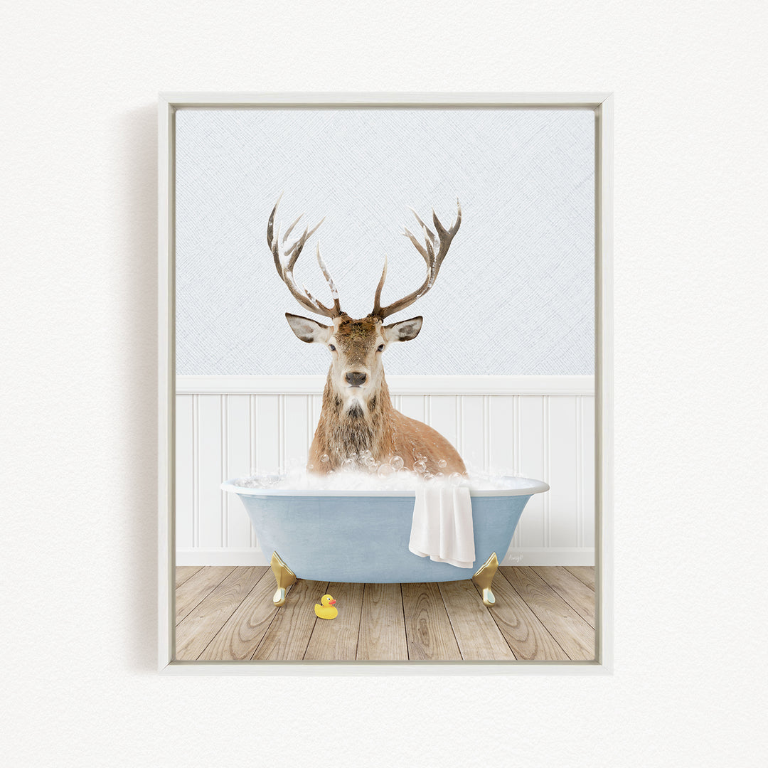 A deer with antlers is sitting in a bathtub filled with water, surrounded by rubber duckies.
