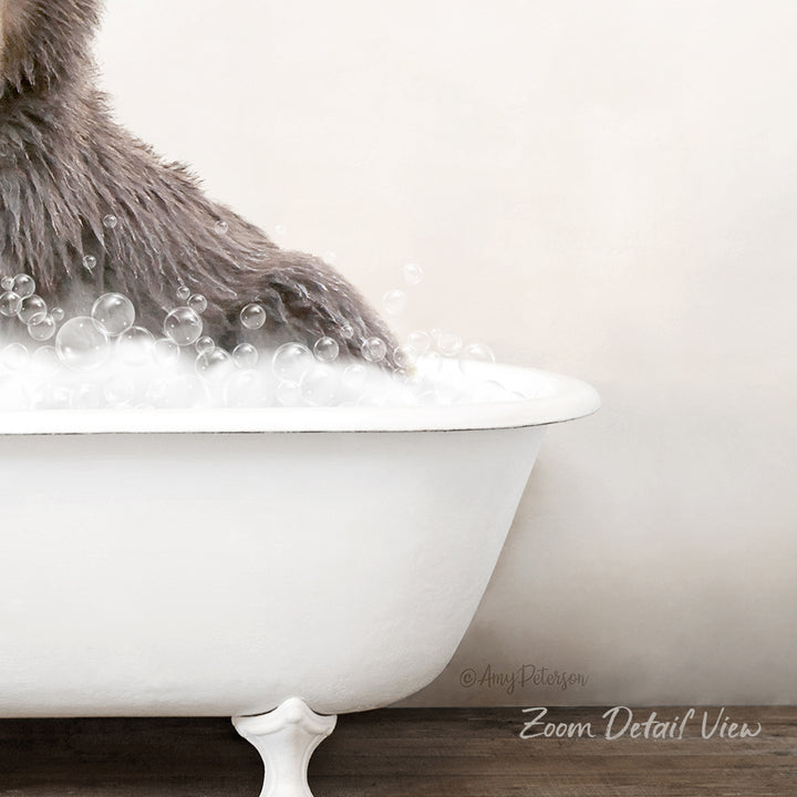 A fluffy gray cat is sitting in a white bathtub filled with bubbles, creating a cozy and playful scene.
