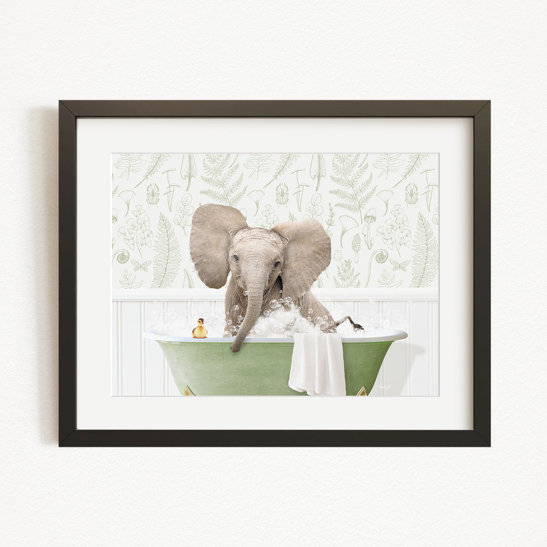 A baby elephant sitting in a green bathtub, surrounded by bubbles and a towel, with a green and white patterned wall behind it.