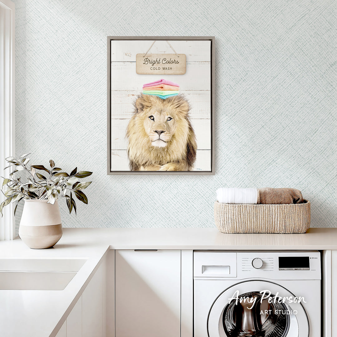 a framed picture of a lion on a wall above a white countertop with a potted plant and a basket of towels.