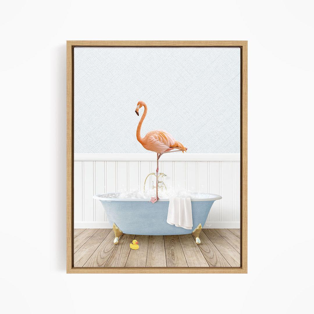 A pink flamingo stands on the edge of a blue bathtub filled with water, with a white towel hanging on the side.