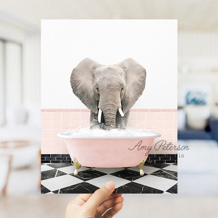 a person holding up a picture of an elephant in a bathtub