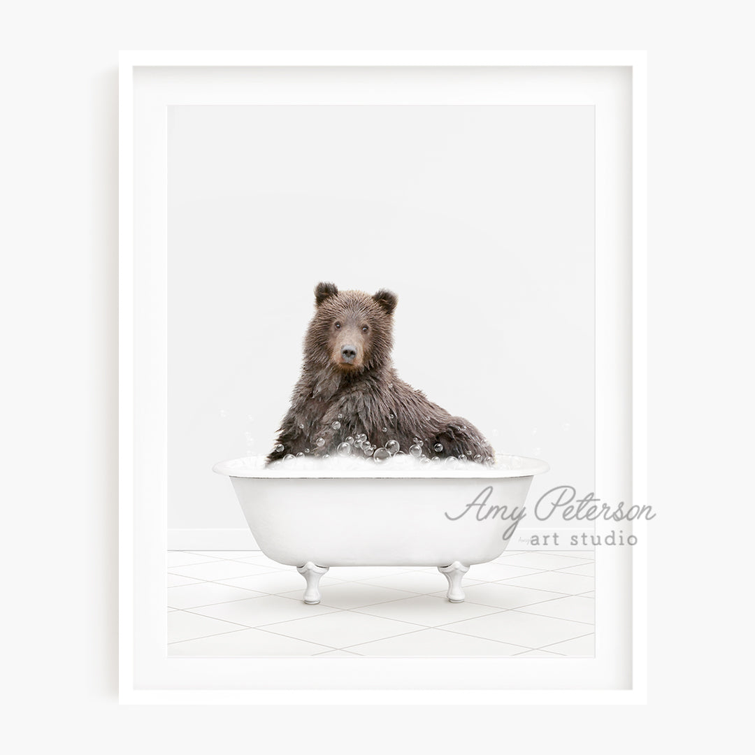 a brown bear sitting in a bath tub