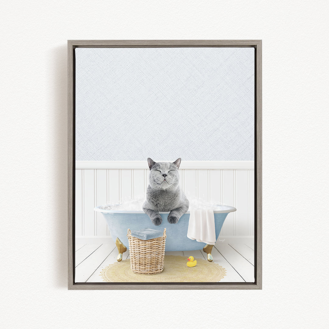 A gray cat sitting in a blue bathtub filled with water, surrounded by a yellow rubber duck and a basket.