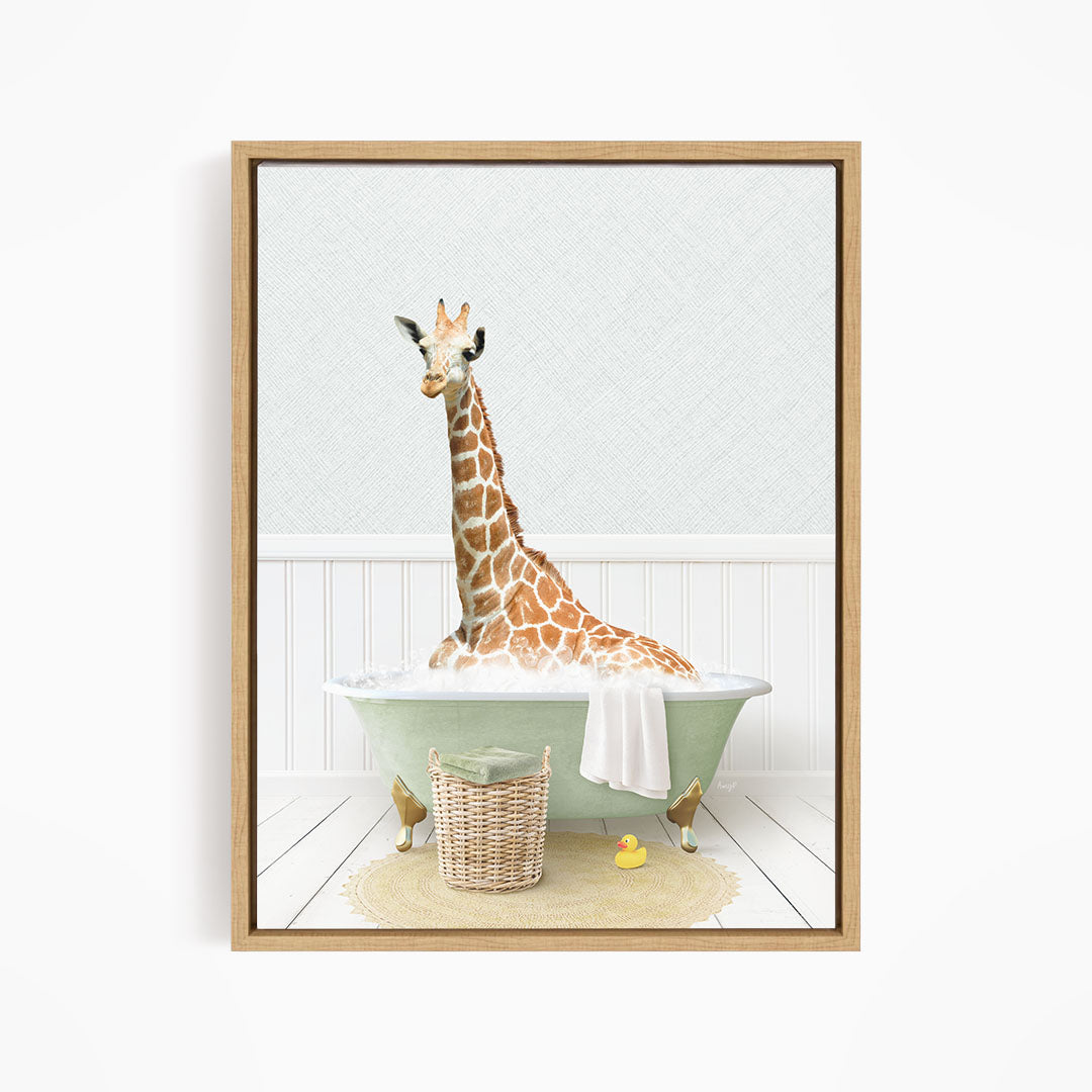 A giraffe sitting in a green bathtub filled with water, surrounded by a basket of toys and a yellow rubber duck.