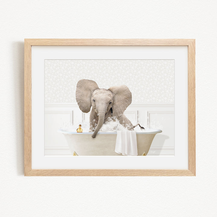 A baby elephant sitting in a bathtub filled with water, surrounded by bubbles.