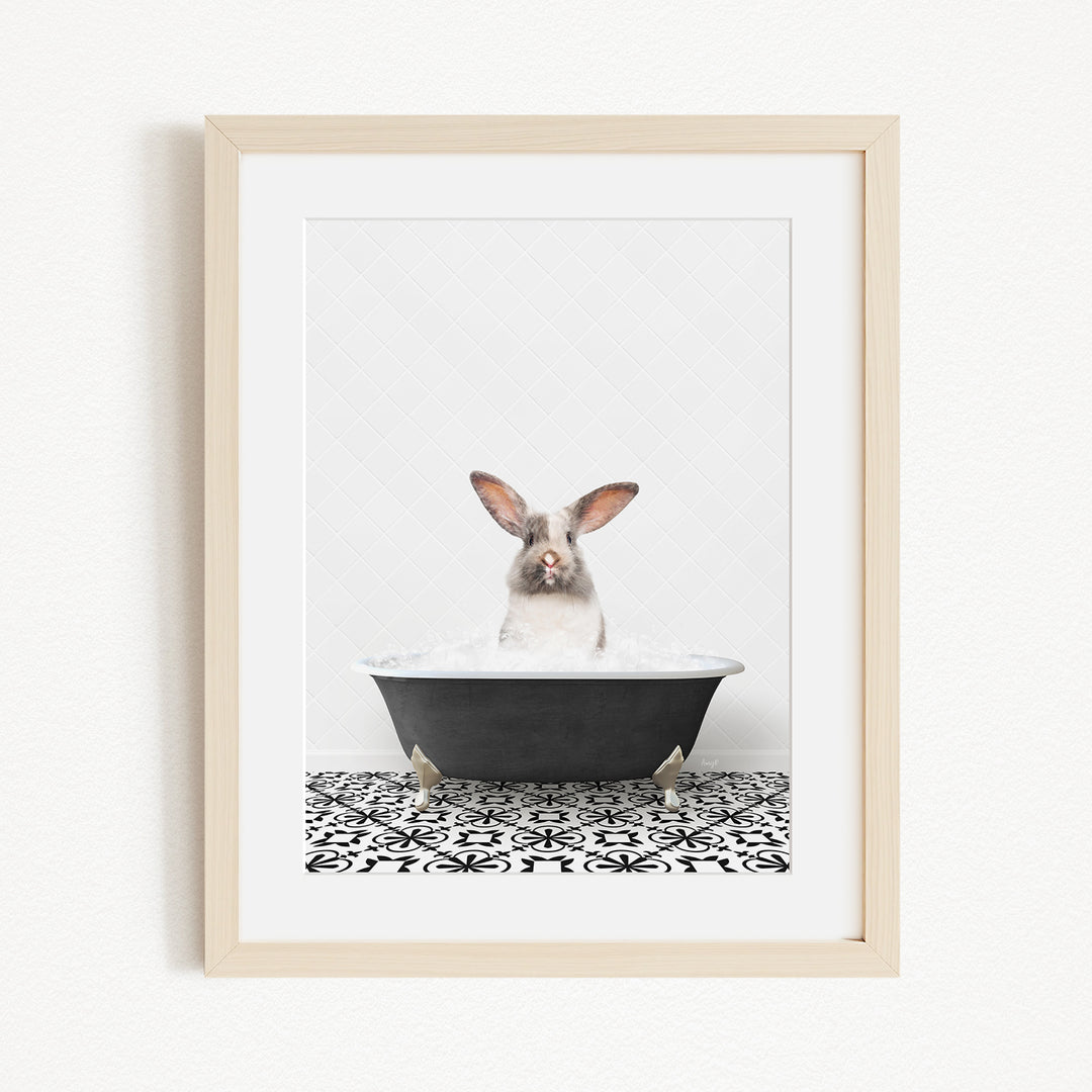 A white rabbit sitting in a black bathtub filled with water, with its head above the water level.