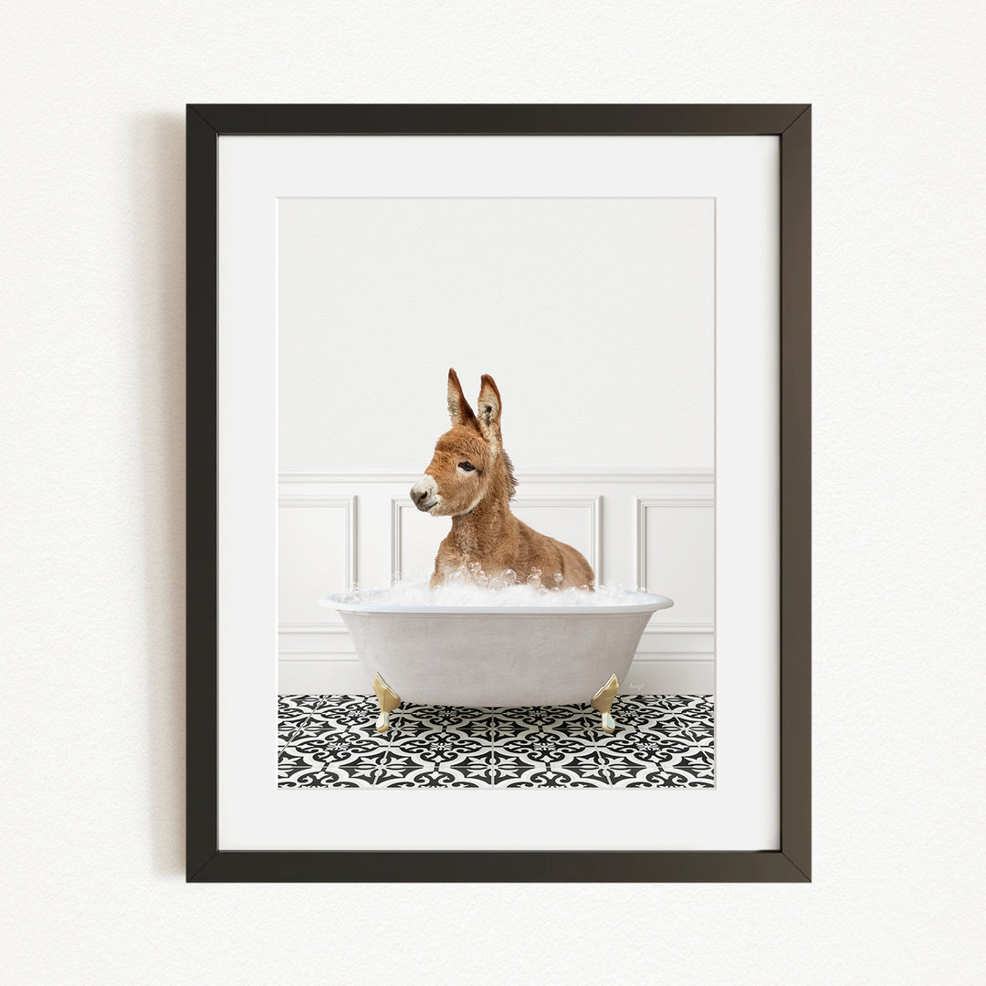A donkey is sitting in a white bathtub filled with bubbles, creating a whimsical and playful scene.