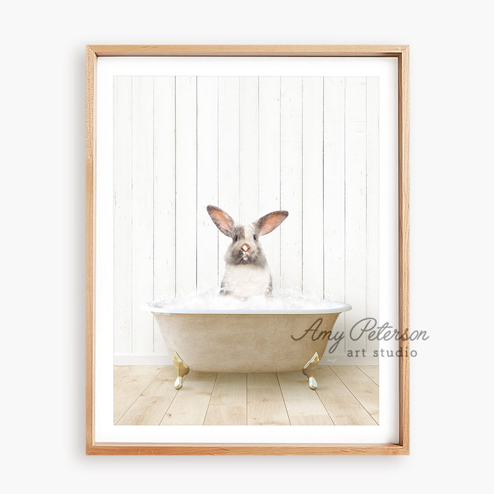 a rabbit sitting in a bathtub with a wooden frame