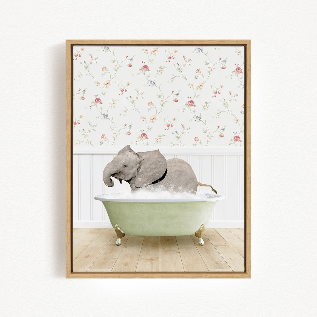 A gray elephant is sitting in a green bathtub filled with water, surrounded by a floral wallpaper.