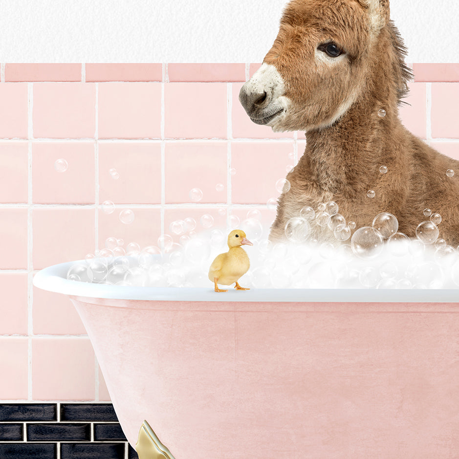 a donkey in a bathtub with bubbles and a rubber duck