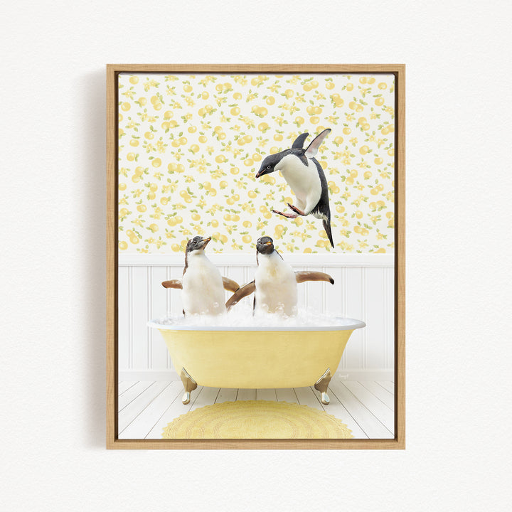 A framed image depicting two penguins sitting in a yellow bathtub, with one penguin flying towards the other in mid-air.