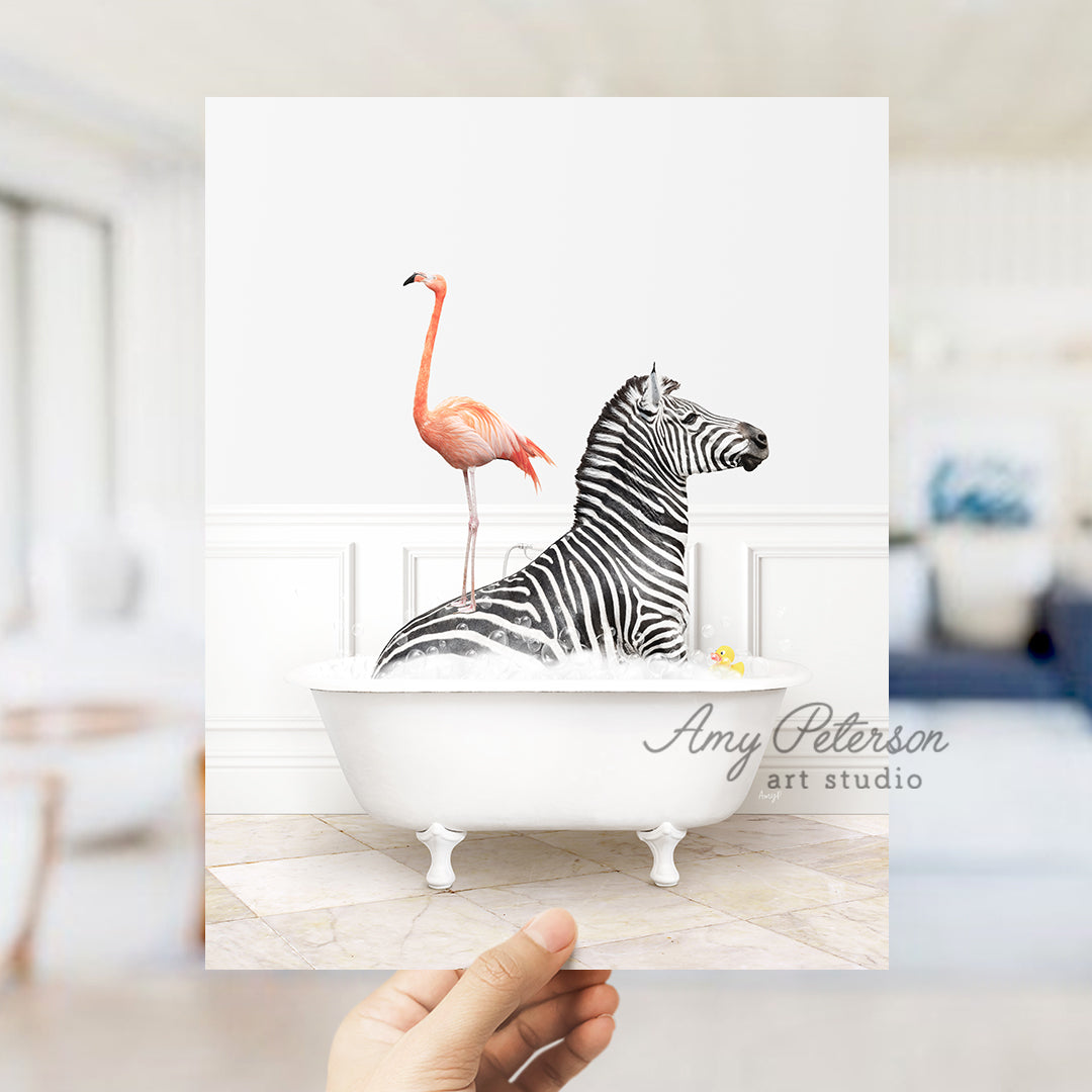 a hand holding up a card with a picture of a zebra and a flamingo