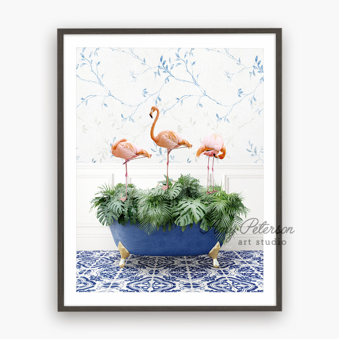 three pink flamingos in a blue planter