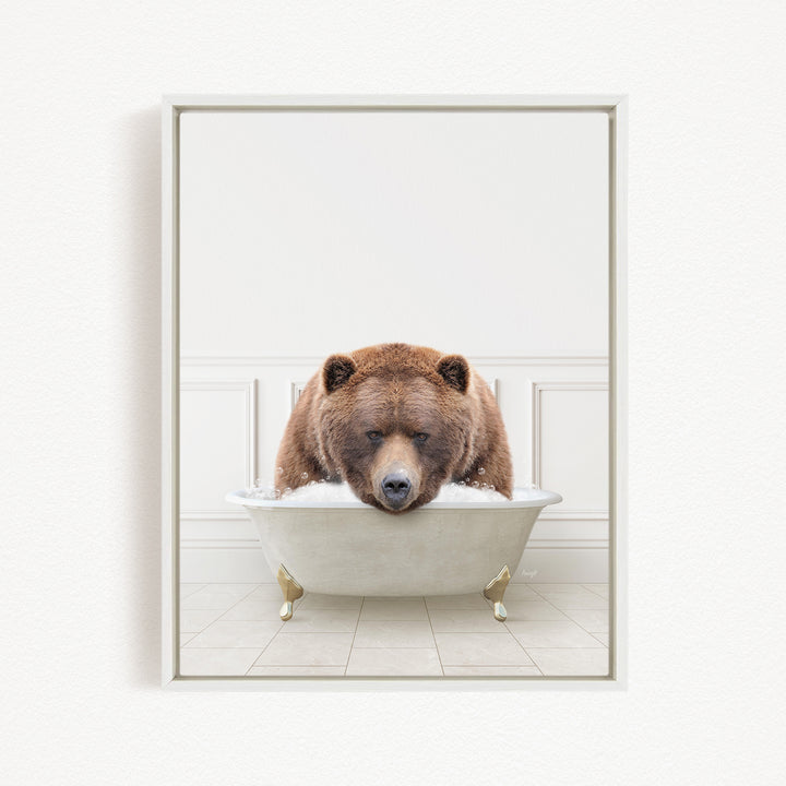 A brown bear is sitting in a white bathtub filled with water, appearing to be enjoying a relaxing bath.