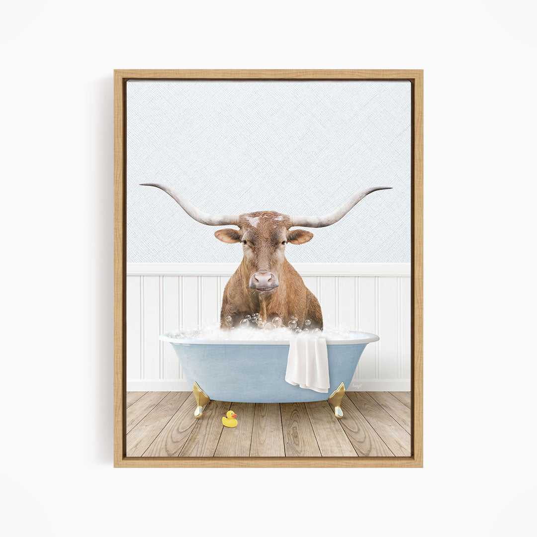 A brown bull with long horns is sitting in a blue bathtub filled with water, surrounded by rubber ducks.