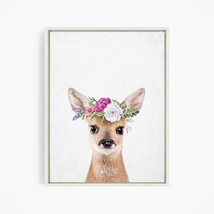 A deer wearing a floral crown on its head.
