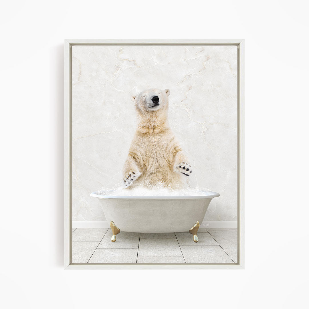 A polar bear standing in a white bathtub filled with water, appearing to be enjoying a bath.