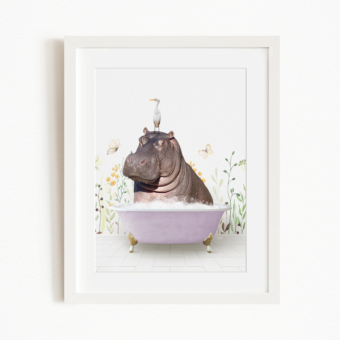 A framed image depicting a hippopotamus sitting in a bathtub, with a seagull perched on its head.
