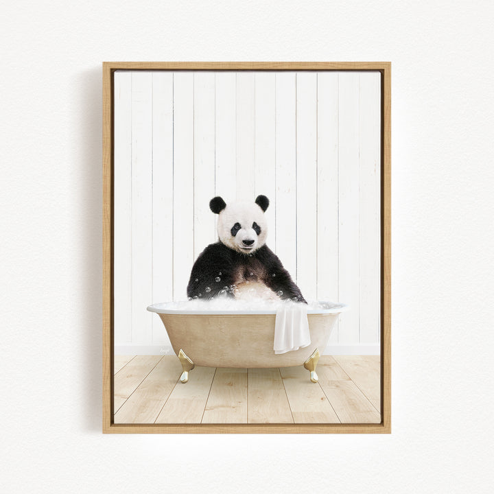 A panda bear sitting in a bathtub filled with water, surrounded by a wooden floor and white walls.