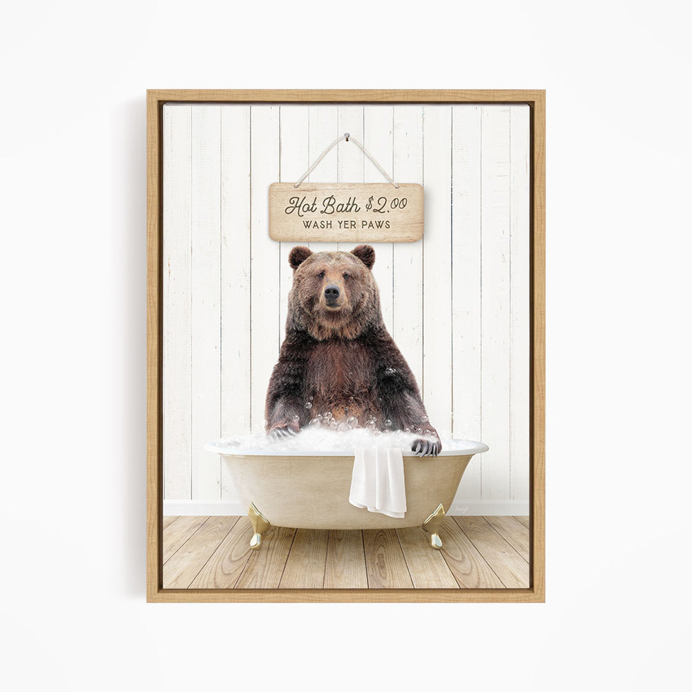A brown bear sitting in a bathtub, with a sign above it that reads "Hot Bath $2.00 WASH YET Paws".