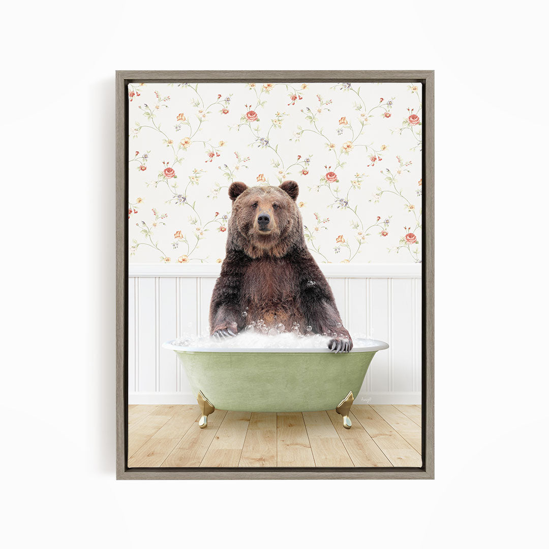 A brown bear sitting in a green bathtub filled with water, surrounded by a floral wallpaper.