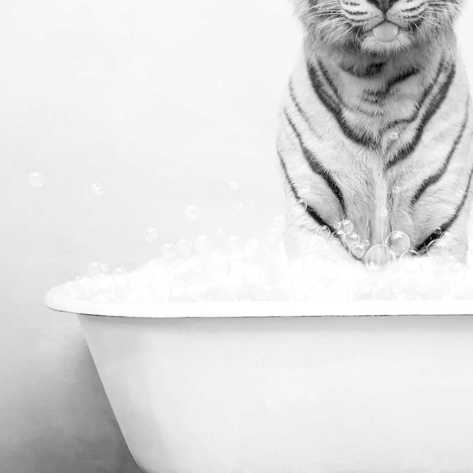 a tiger sitting on top of a bath tub filled with bubbles