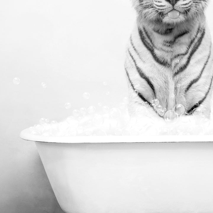 a tiger sitting on top of a bath tub filled with bubbles