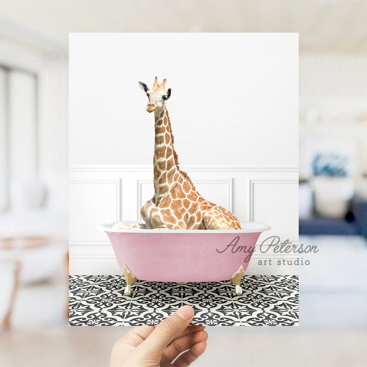 a giraffe sitting in a pink bath tub