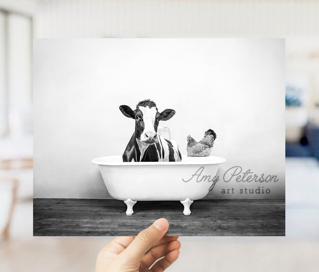 a black and white photo of a cow in a bathtub