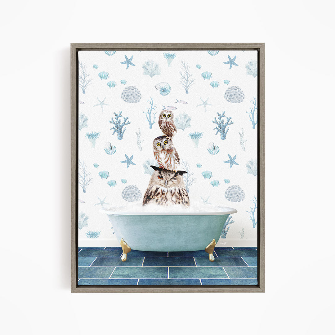 A framed image depicting a group of owls sitting in a bathtub, surrounded by a blue and white ocean-themed wallpaper.