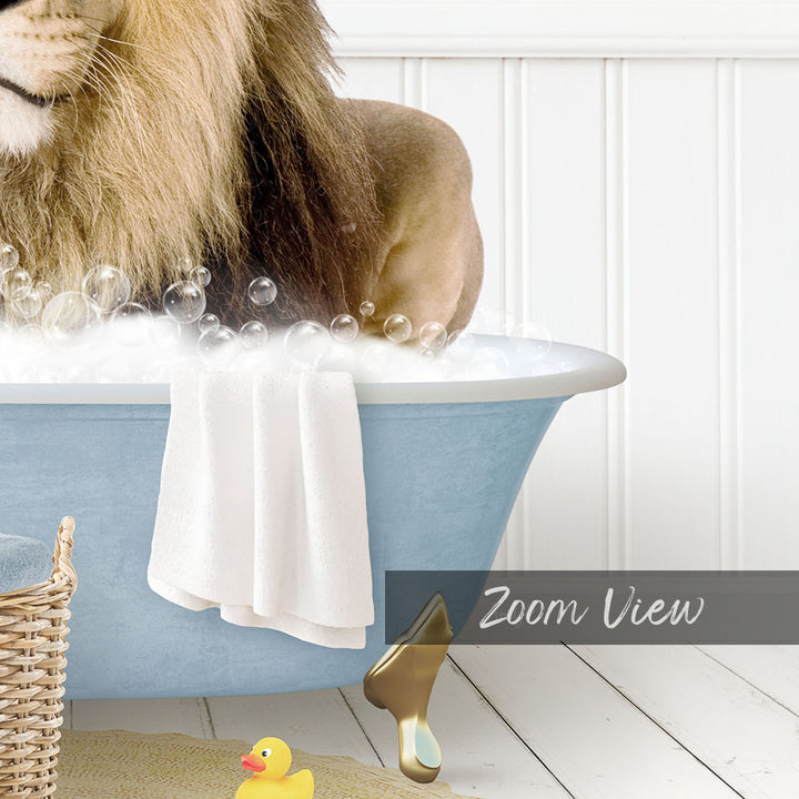 A lion is sitting in a blue bathtub filled with bubbles, surrounded by a yellow rubber duck and a white towel.