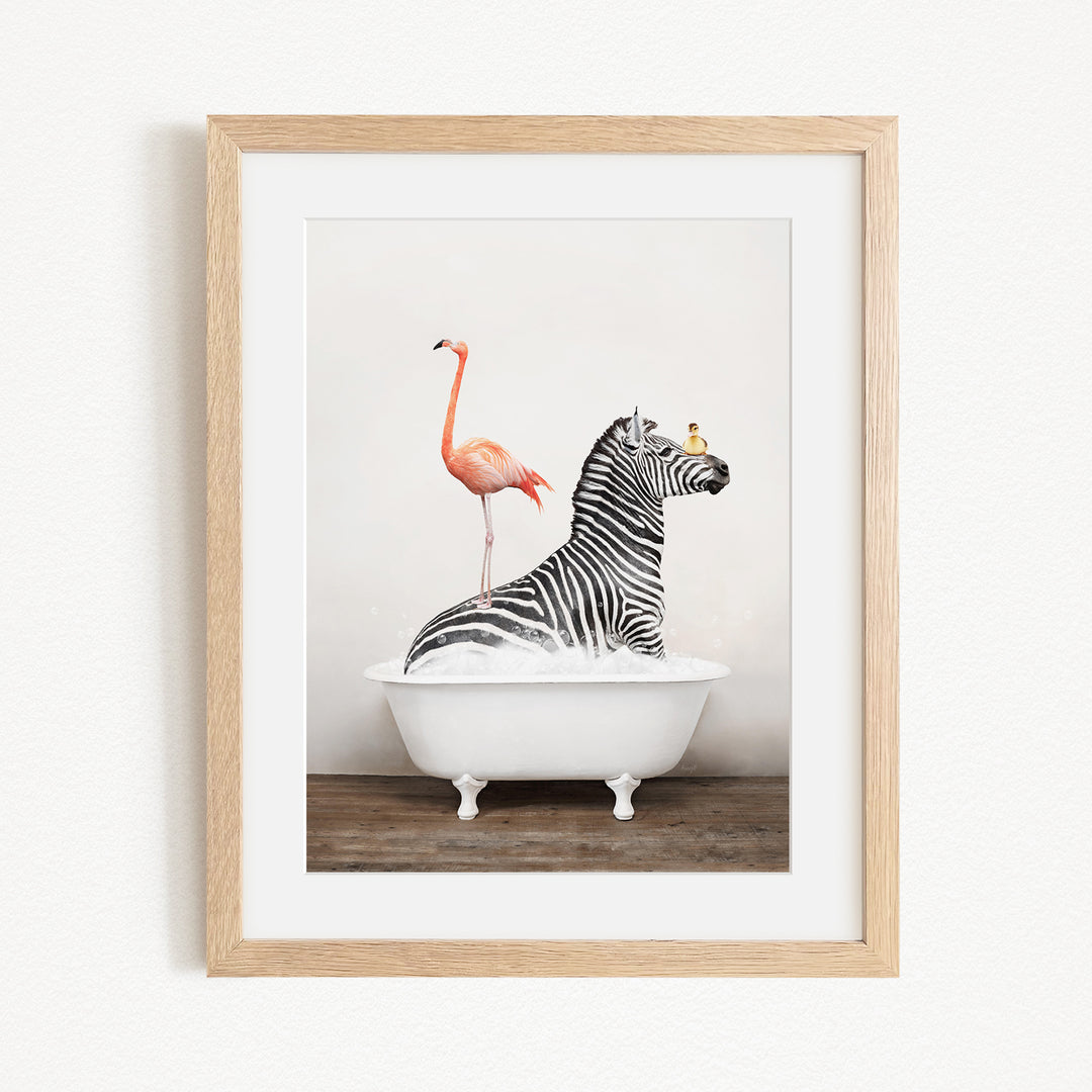 A framed image depicting a zebra sitting in a bathtub, with a flamingo standing on its back and a bird perched on its head.