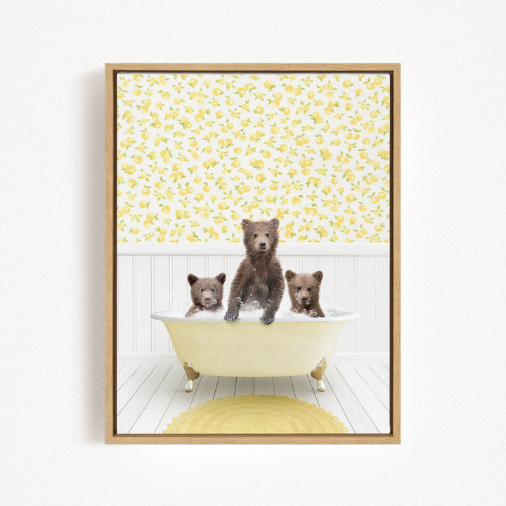 A framed image depicting three bears sitting in a bathtub, with a yellow floral pattern on the wall behind them.