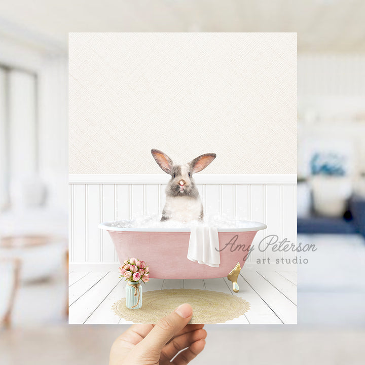 a person holding up a card with a picture of a rabbit in a bathtub