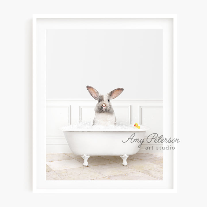 a rabbit sitting in a bathtub with a rubber duck in it