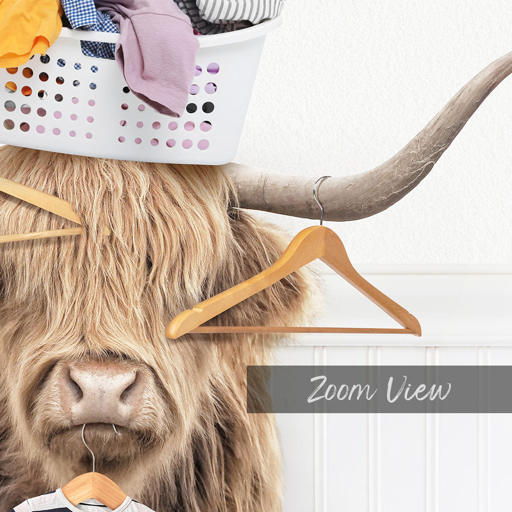 A long-haired, horned animal with a basket of clothes on its head, and a wooden hanger hanging from its horns.