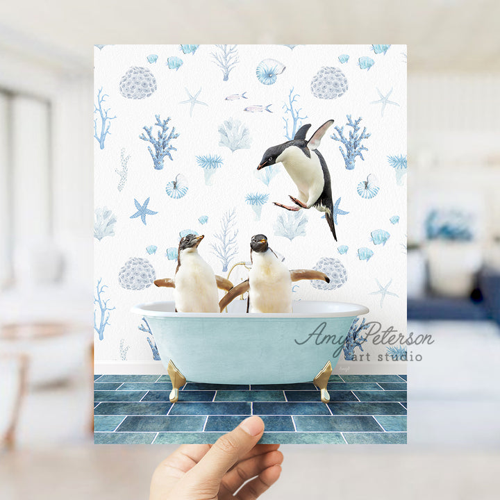 a hand holding a card with two penguins in a bathtub