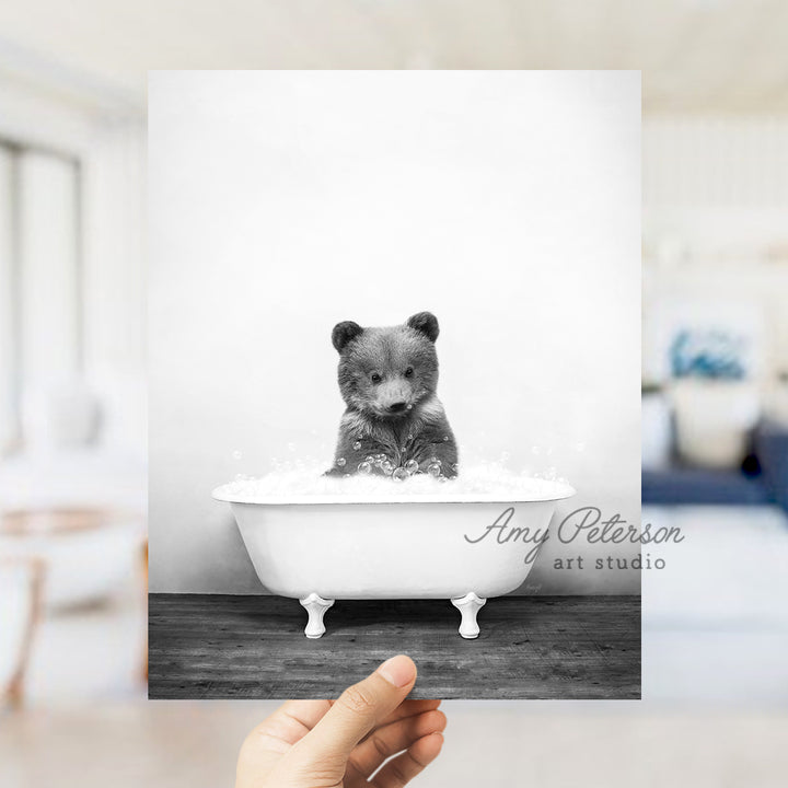 a black and white photo of a bear in a bathtub