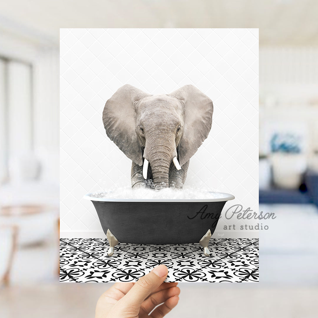 a person holding up a card with an elephant in a bathtub