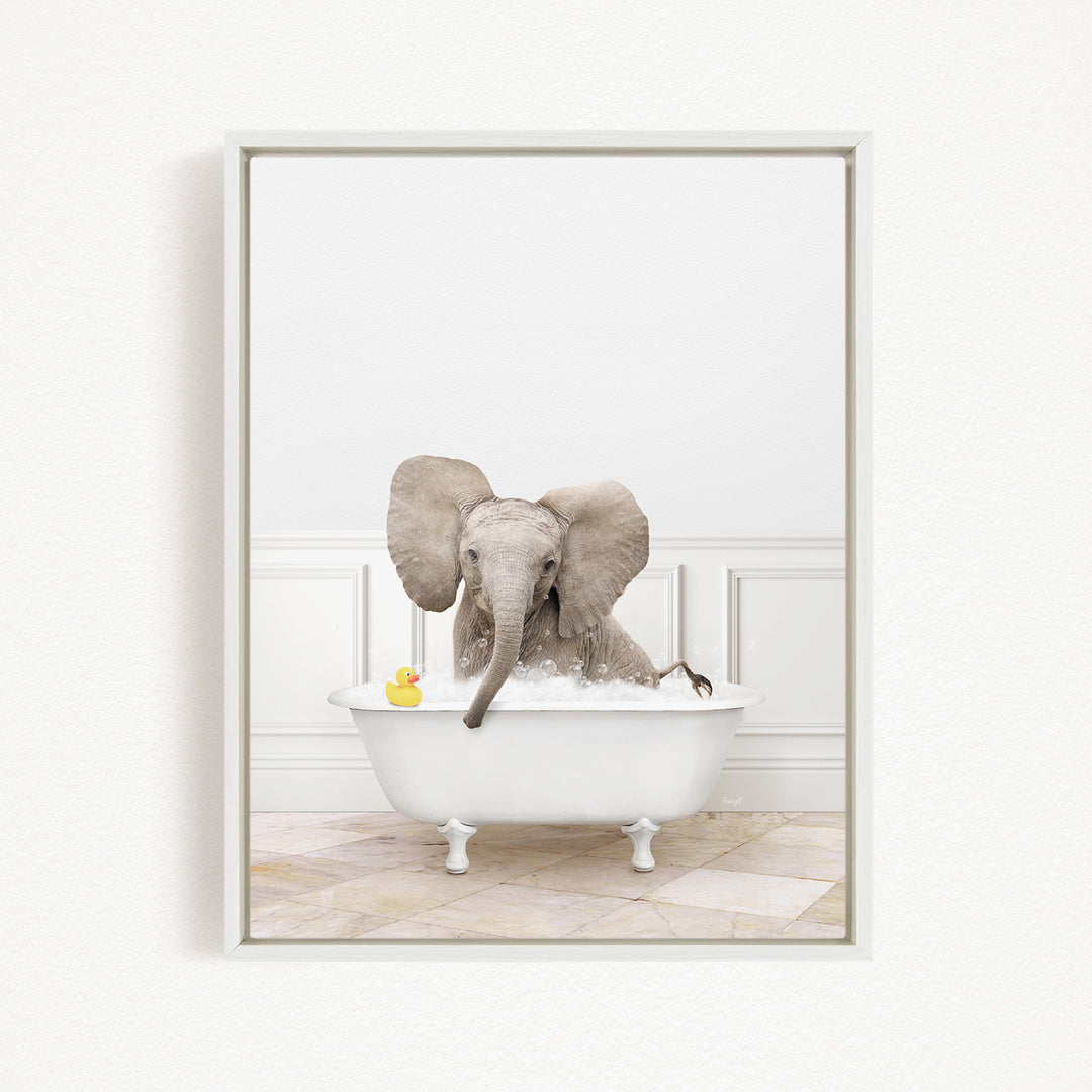 A baby elephant sitting in a white bathtub, with a rubber duck floating on the water.