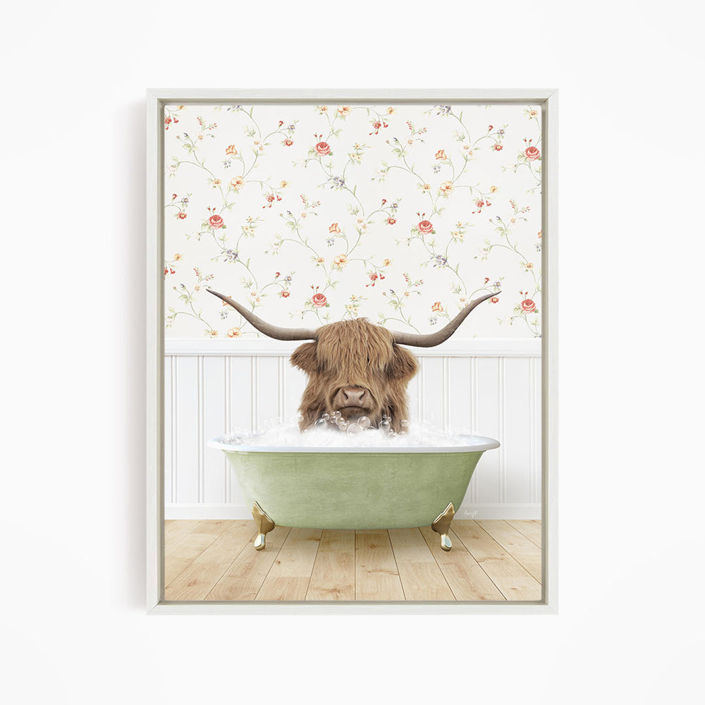 A brown cow with long horns is sitting in a green bathtub filled with water, surrounded by a floral wallpaper.